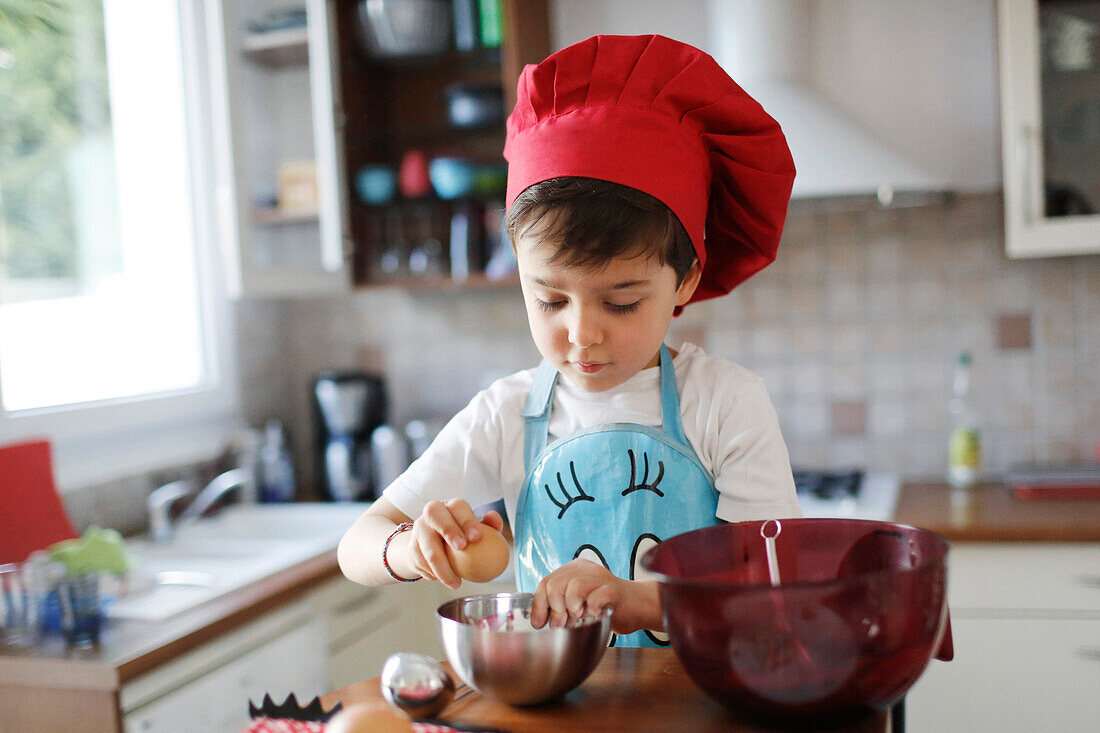 A little boy cooking a chocolate cake