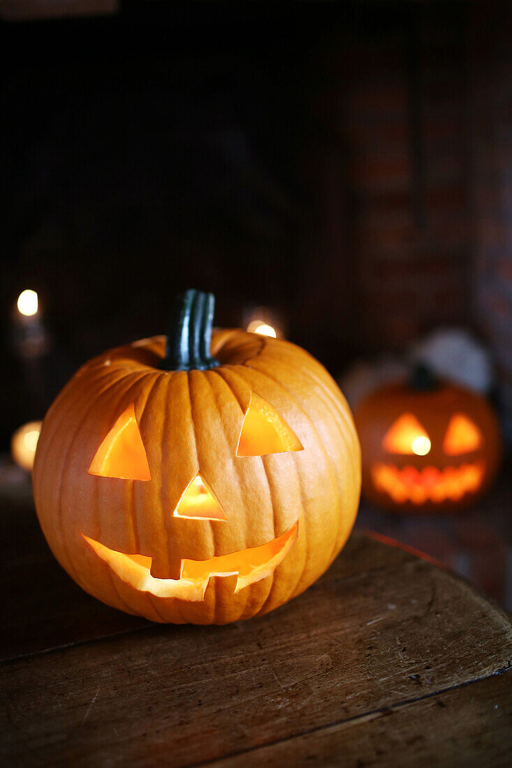 Still life of jack-o-lantern and illuminated Halloween pumpkins