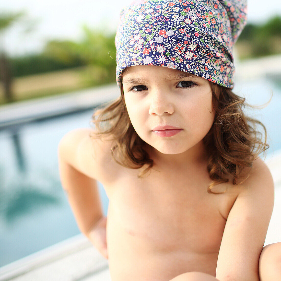 Portrait of a 4 years old girl near a pool