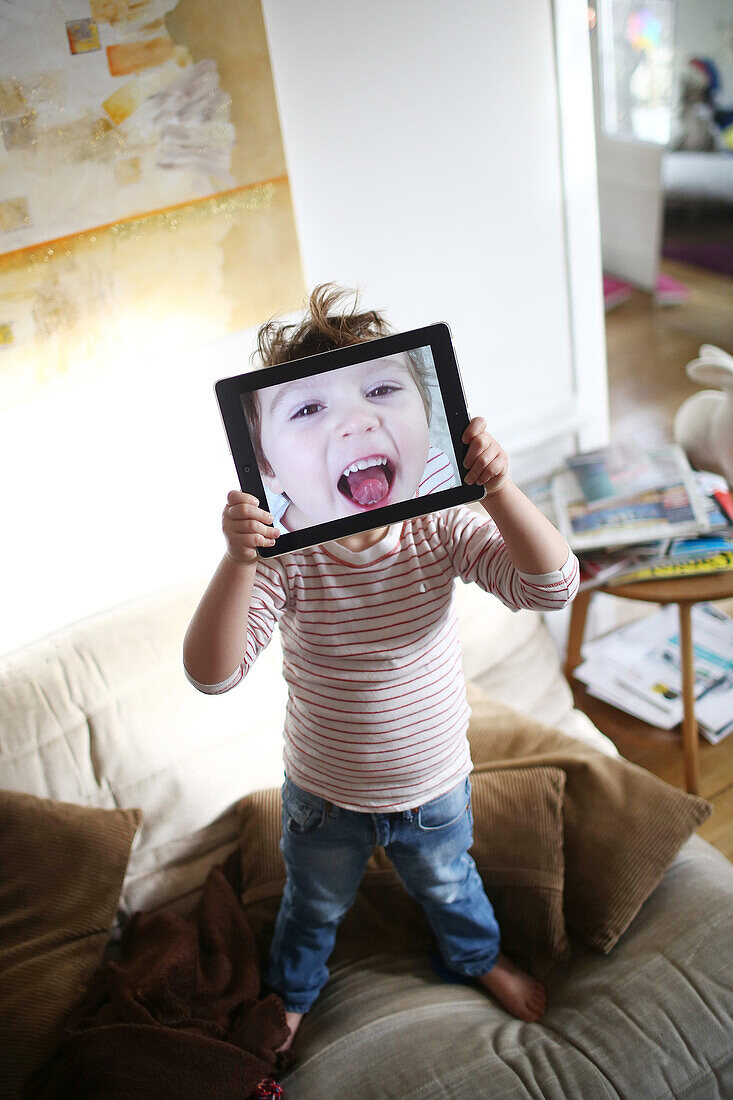 Little boy playing with a tablet