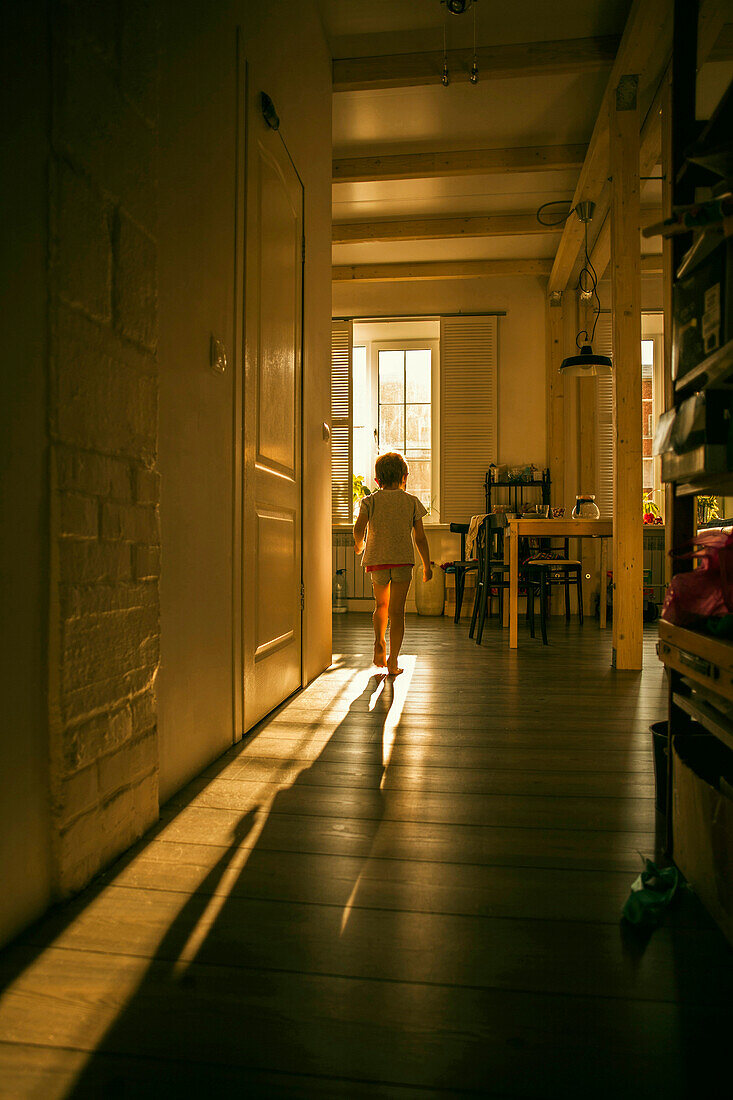Caucasian girl walking in kitchen