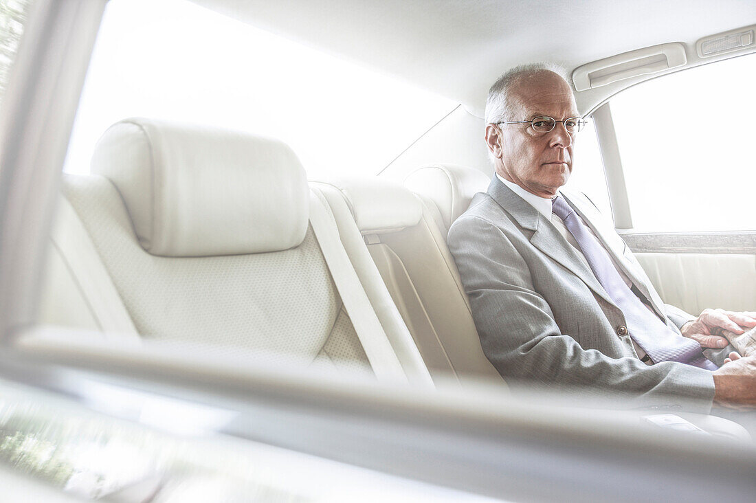 Caucasian businessman sitting in car
