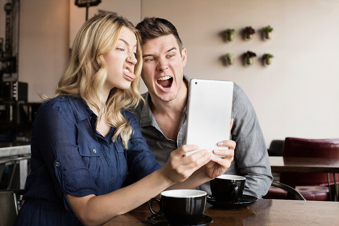 Caucasian couple using digital tablet together