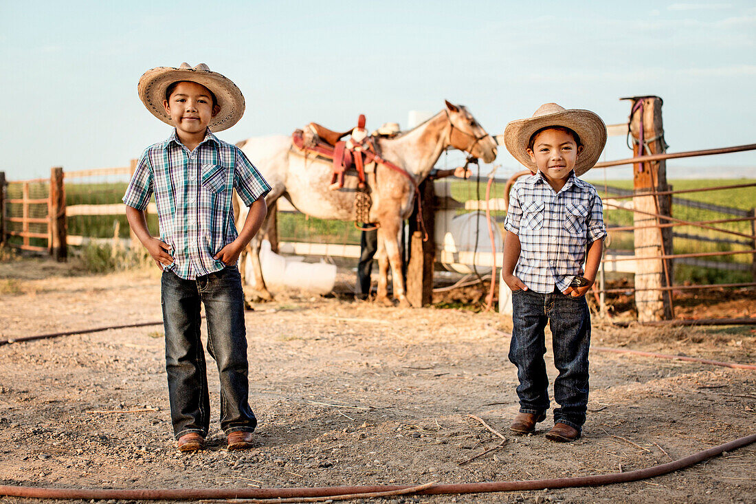 Hispanic boys smiling on ranch