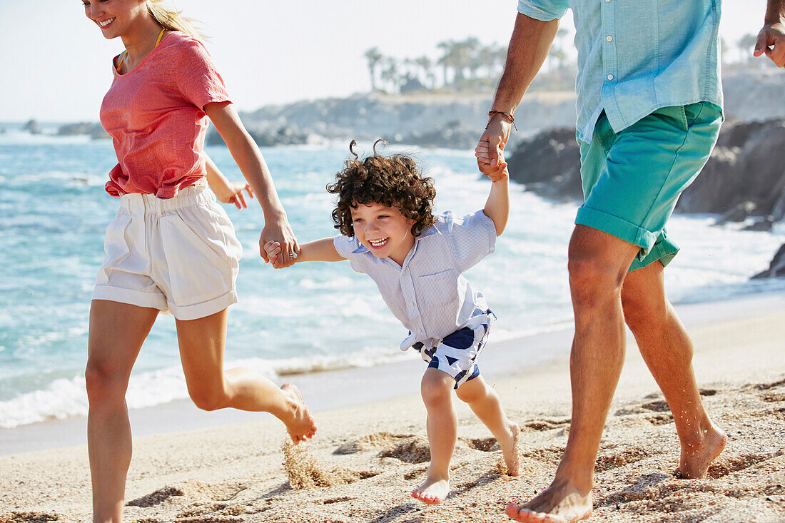 Family running together on beach