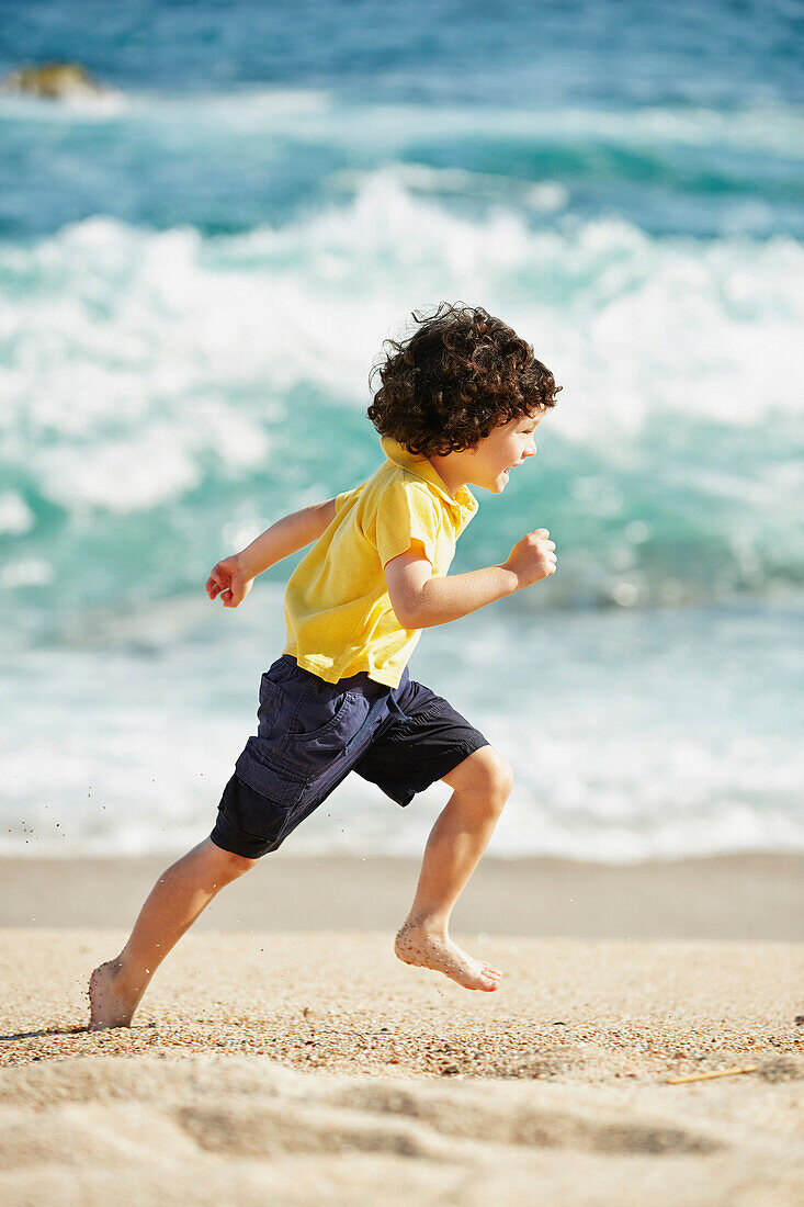 Boy running on beach