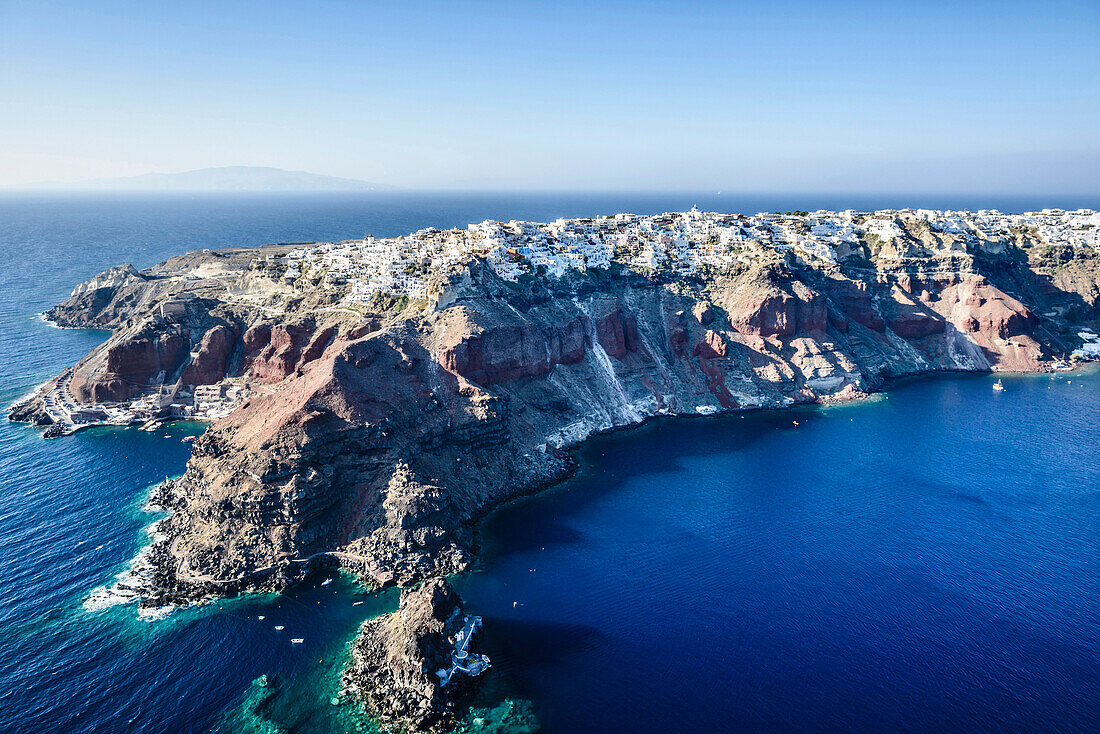 Aerial view of city built on rocky coastline, Oia, Egeo, Greece