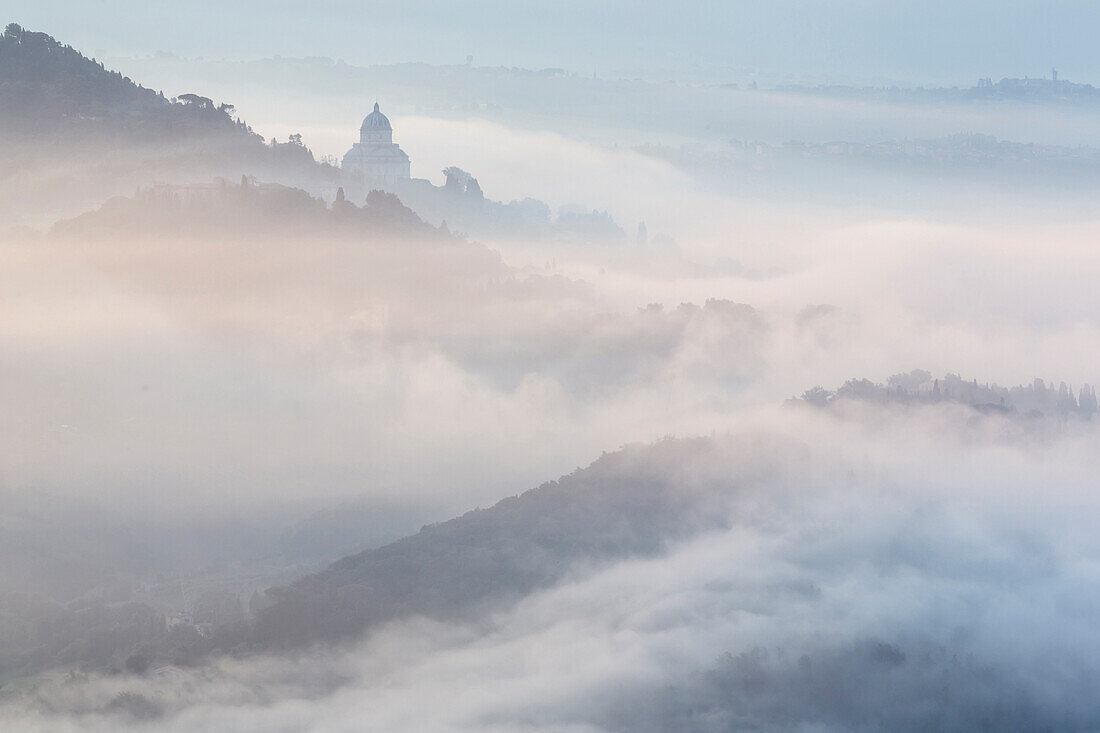 Morning fog over hills and town, Todi, Umbria, Italy