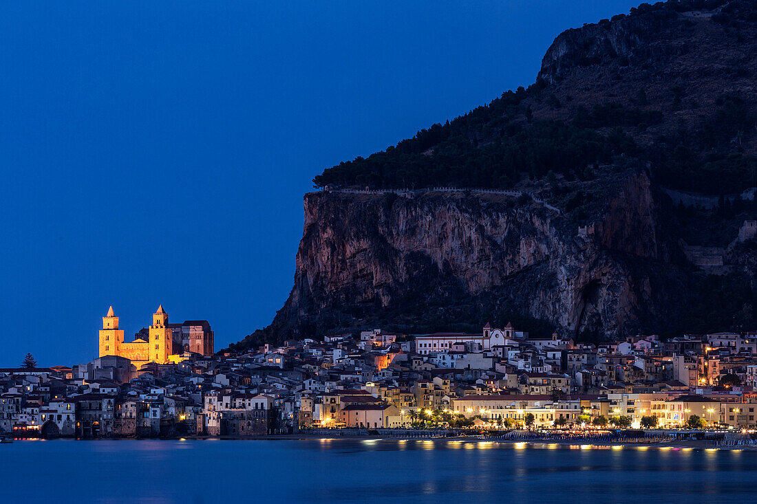 Cefalu Cathedral and waterfront illuminated at night, Cefalu, Sicily, Italy