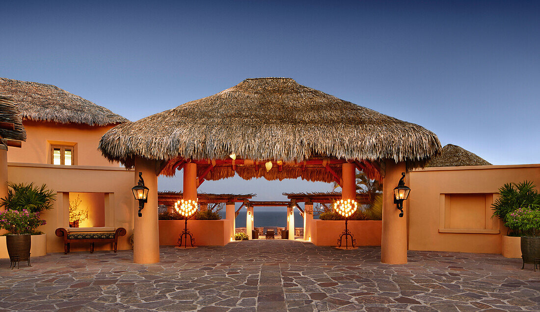 Thatched roof over stone walkway at resort, Cabo San Lucas, BCS, Mexico