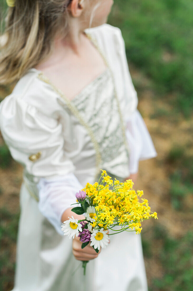 Young Girl Dressed as Princess Holding Bouquet of Flowers