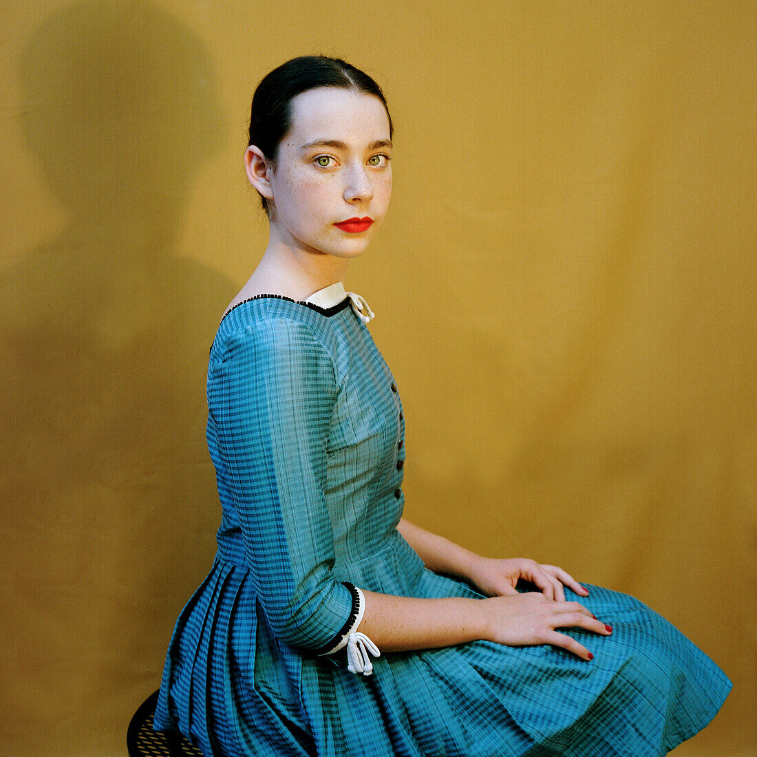 Serious Teenage Girl with Red Lips in Blue Dress, Portrait