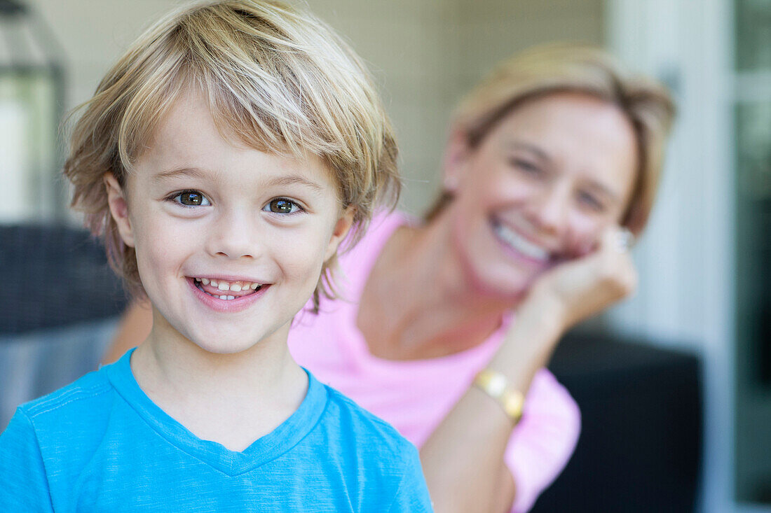 Caucasian boy smiling with mother, C1