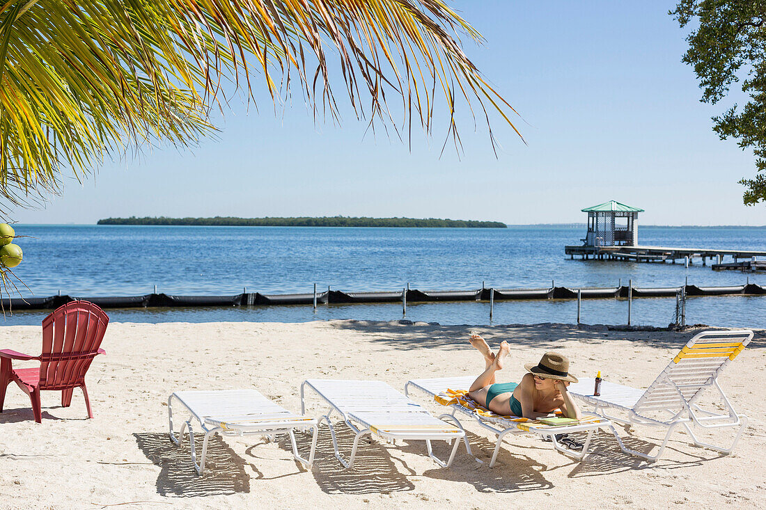 Caucasian woman relaxing on tropical beach, Florida Keys - Big Pine Key, Florida, United States