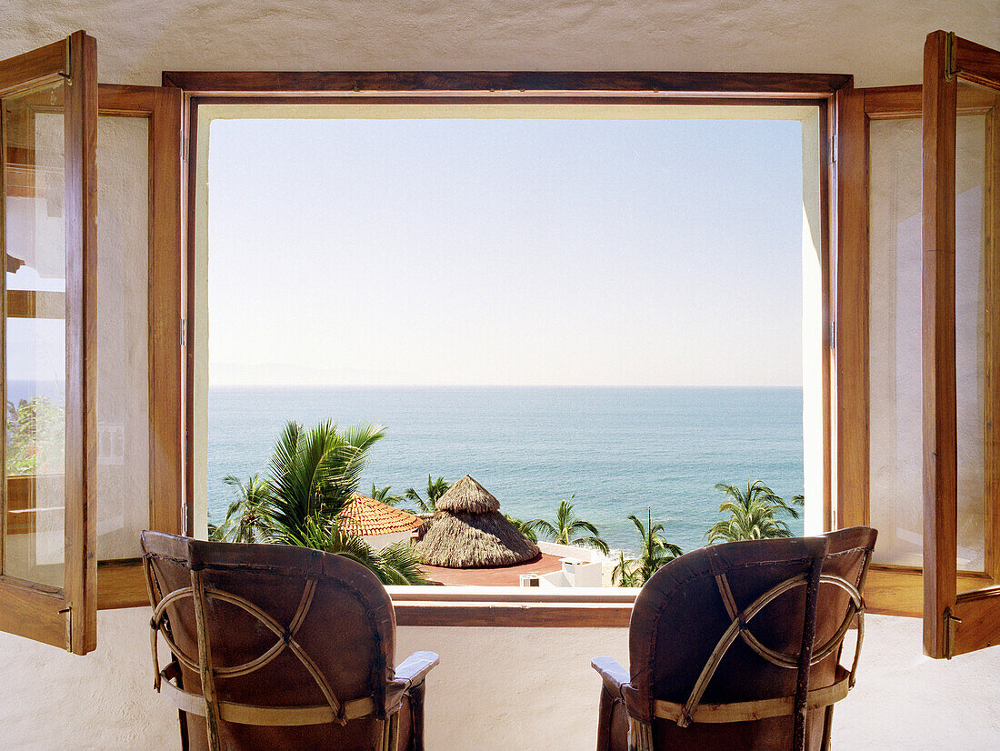Empty chairs facing open window overlooking ocean, Puerto Vallarta, Puerto Vallarta, Mexico