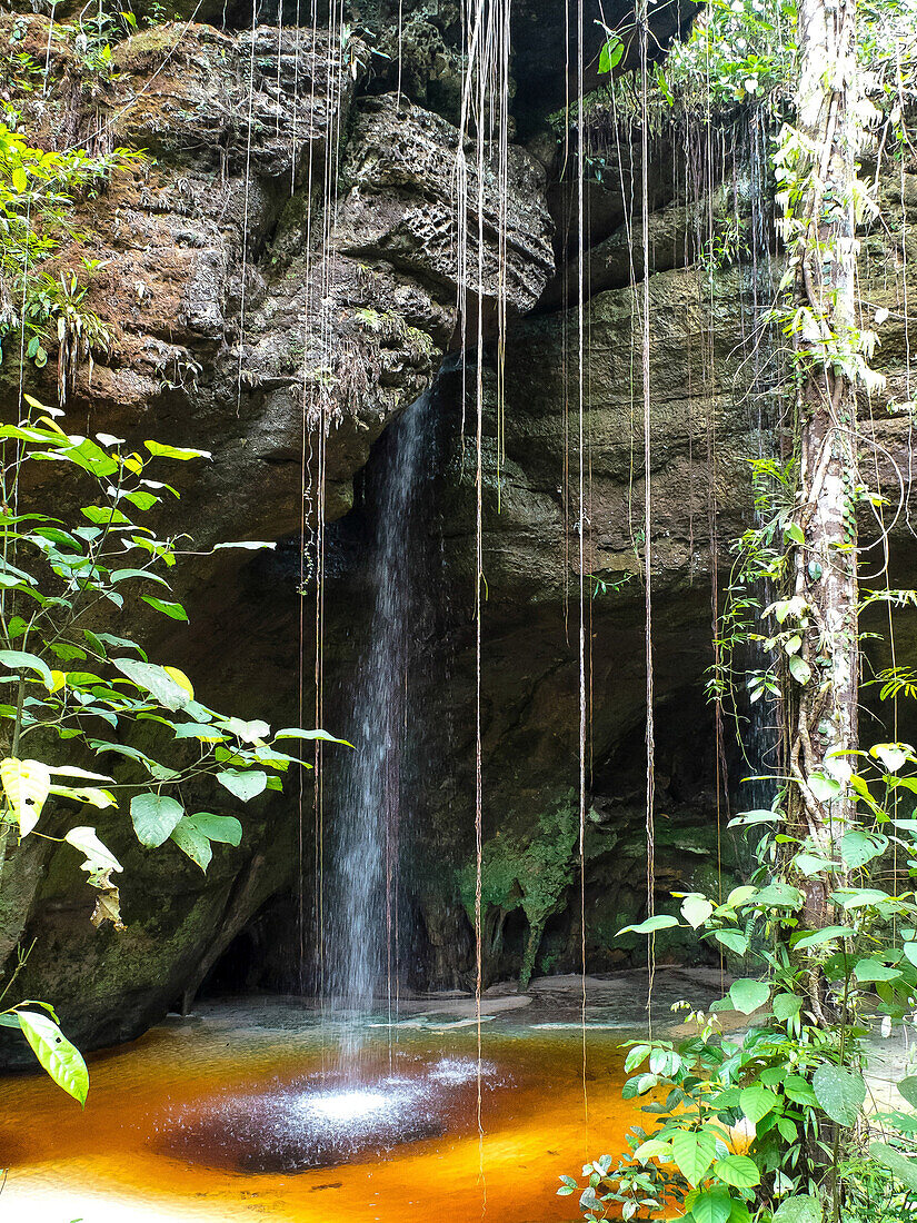 Brazil, Amazonas, waterfall in front of a cave