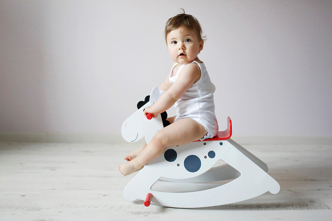 Baby girl on a rocking horse
