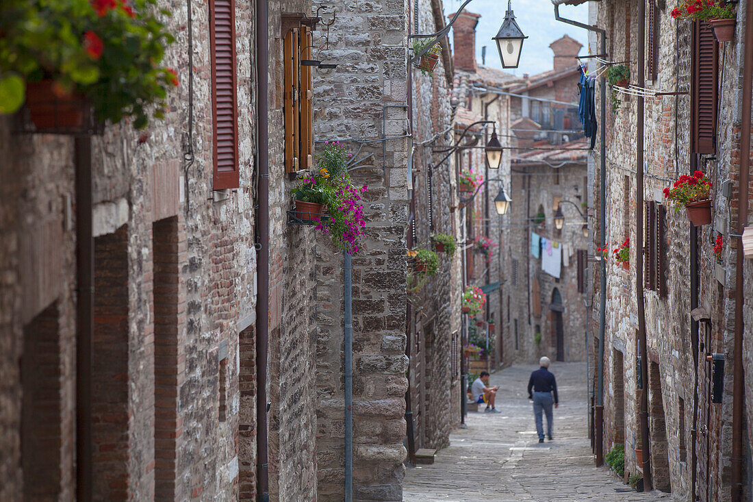 Man walking along Via Aquilante, Gubbio, Umbria, Italy, Europe