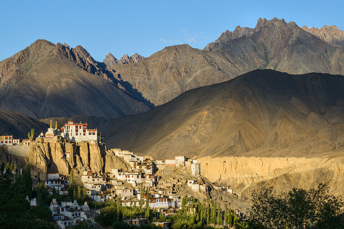The town and monastery of Lamayuru, backed by mountains in the evening sun, Ladakh, Himalayas, India, Asia