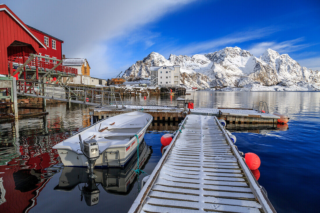 Jetty covered with snow after a night snowfall and boats docked in the harbor of Henningsvaer, Lofoten Islands, Arctic, Norway, Scandinavia, Europe
