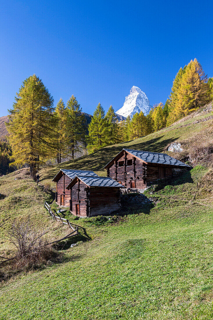 The unique shape of the Matterhorn seen from a little group of mountain huts by Zermatt, Swiss Canton of Valais, Swiss Alps, Switzerland, Europe