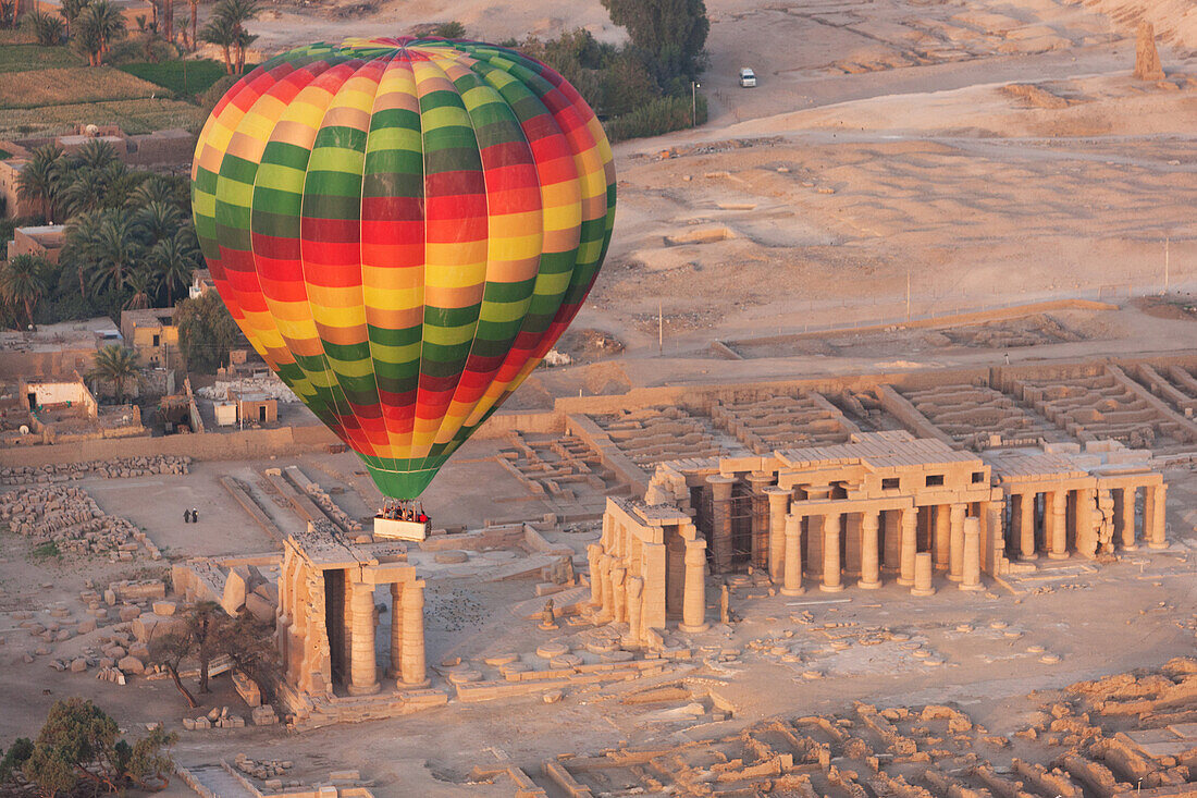 A hot air balloon flight over a ruined temple near Luxor, Thebes, Egypt, North Africa, Africa
