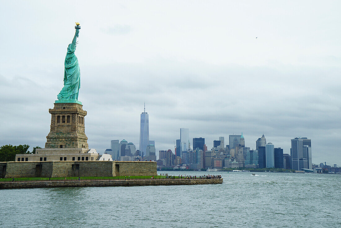 Statue of Liberty with the Lower Manhattan skyline and One World Trade Center beyond, New York City, New York, United States of America, North America