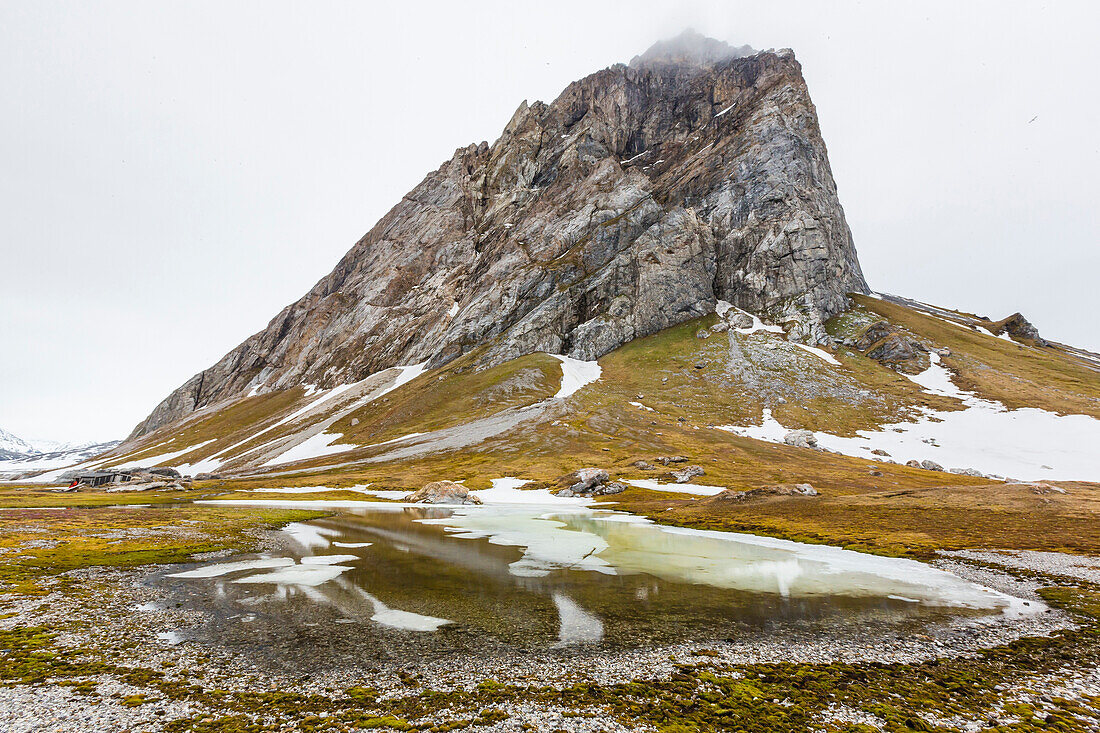 Gnalloden reflected in meltwater pond at Hornsund, Spitsbergen, Svalbard, Arctic, Norway, Scandinavia, Europe