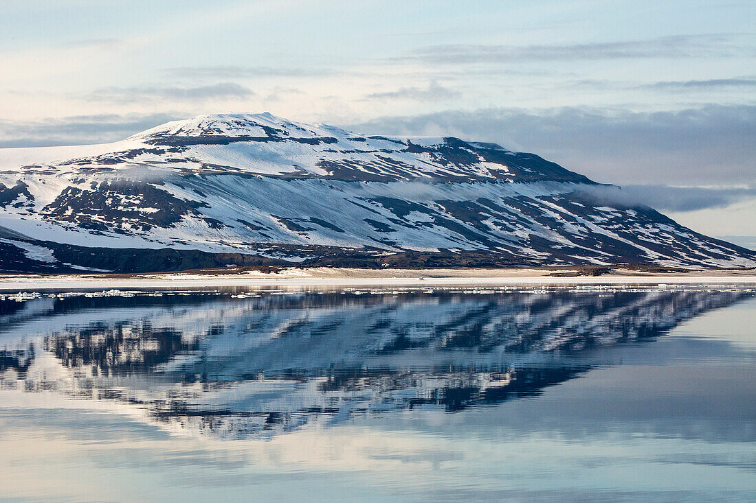 Snow-capped mountains reflected in the calm waters of Olga Strait, Svalbard, Arctic, Norway, Scandinavia, Europe