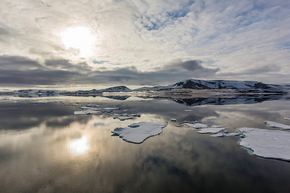 Sun and sky reflected in the calm waters of Olga Strait, Svalbard, Arctic, Norway, Scandinavia, Europe