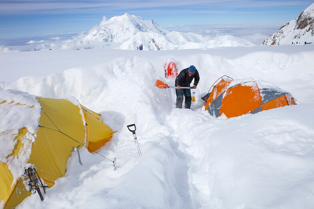 A mountain ranger is digging out tents after a snowstorm covered them during the night in 14k camp on Mount McKinley, Alaska.     Climbers are advised to spare no expense on a expedition-quality tent as it can mean the difference between life and death du