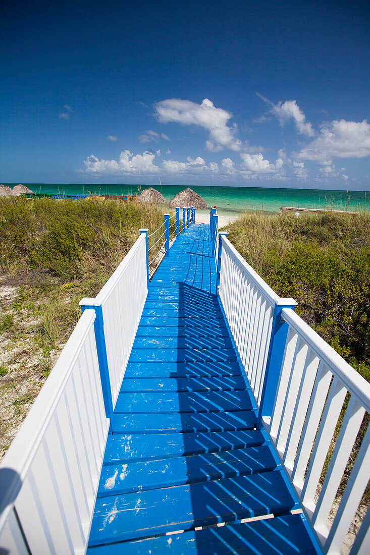 A blue and white boardwalk leads to Playa Pilar beach on Cayo Guillermo, Cuba.