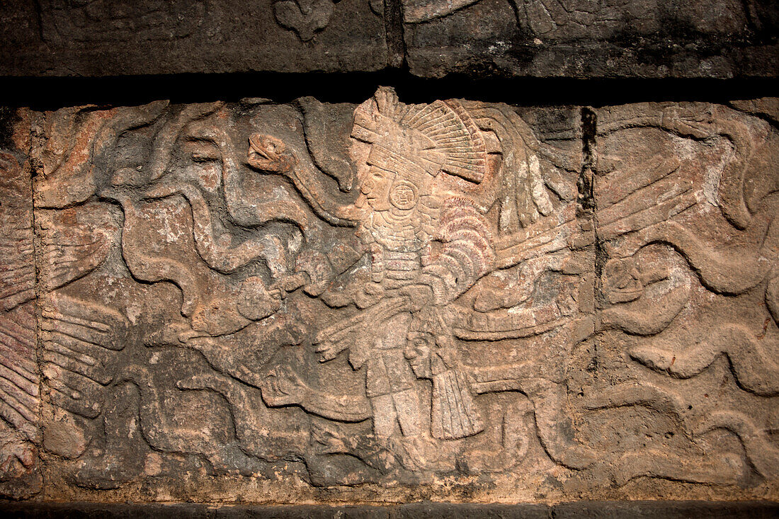 The image of a Toltec warrior with a snake in the right arm  and holding a human head with his left hand is displayed in the Mayan city of Chichen Itza, Yucatan Peninsula, Mexico