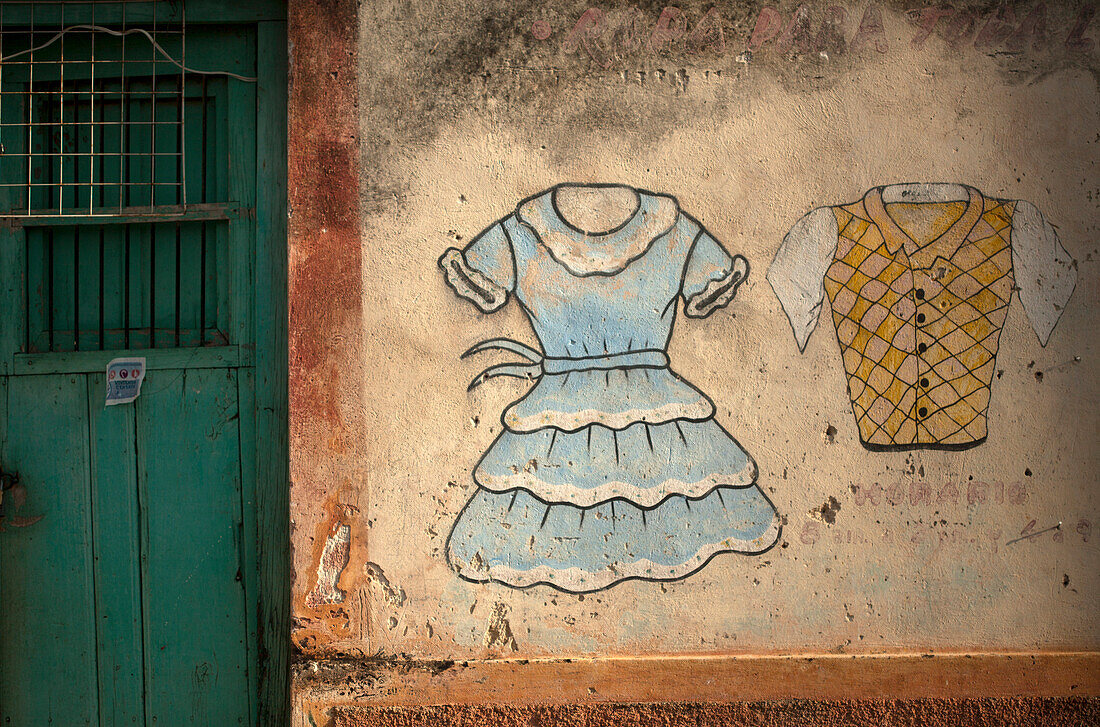 A painting of a dress and a shirt decorate a wall in a clothing store in Santa Elena,Yucatan, Yucatan Peninsula, Mexico