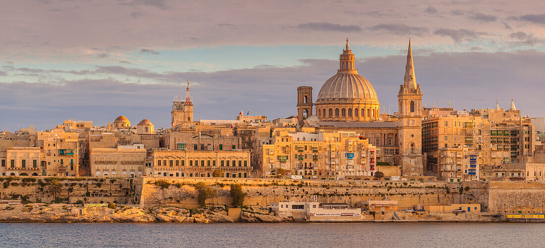 Valletta skyline panorama at sunset with the Carmelite Church dome and St. Pauls Anglican Cathedral, Valletta, Malta, Mediterranean, Europe