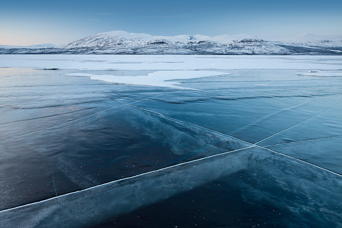 A frozen lake, so clear its possible to see through the ice, near Absiko, Sweden, Scandinavia, Europe