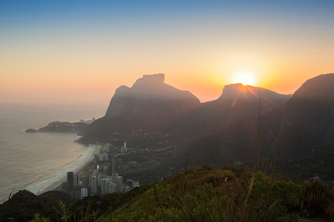 Sunset over Pedra da Gavea mountain (Gavea Rock), with the neighbourhood of Sao Conrado in foreground, Rio de Janeiro, Brazil, South America