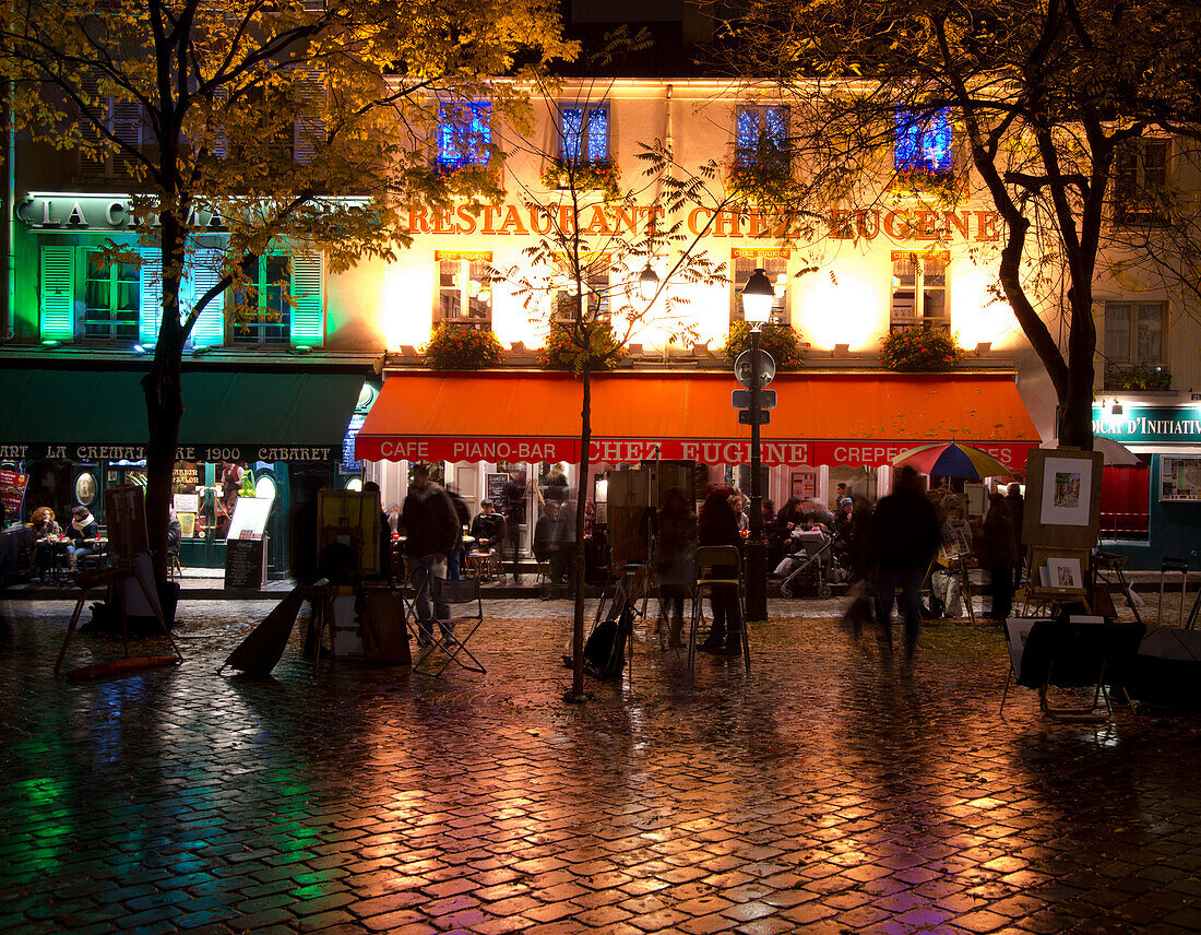 Restaurants and cafes lit at night in the Montmartre area of Paris, France, Europe