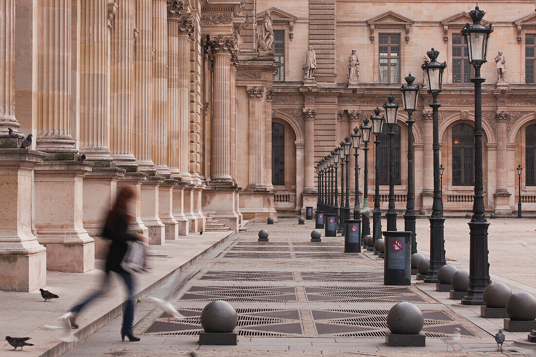 A woman walks through the Louvre Museum in Paris, France, Europe