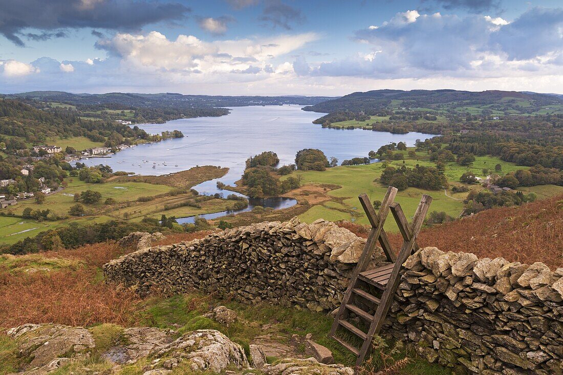 Drystone wall and stile with views to Windermere in autumn, Lake District National Park, Cumbria, England, United Kingdom, Europe