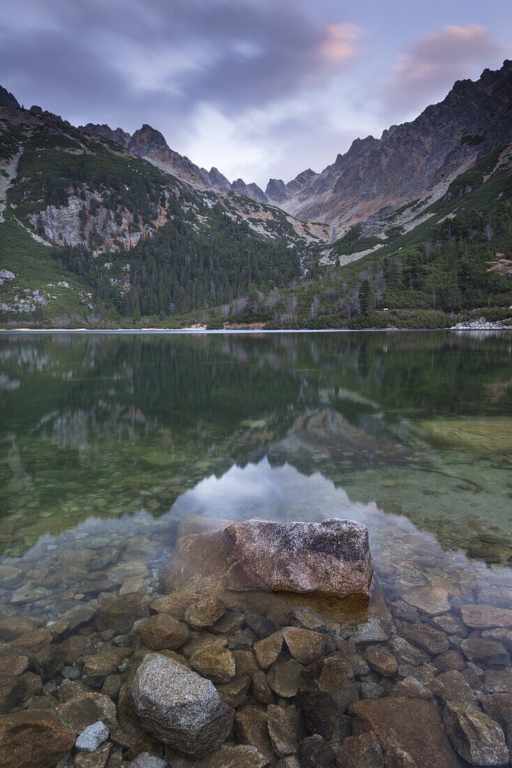 A mirror still Popradske Pleso lake in the High Tatras, Tatra Mountains, Slovakia, Europe
