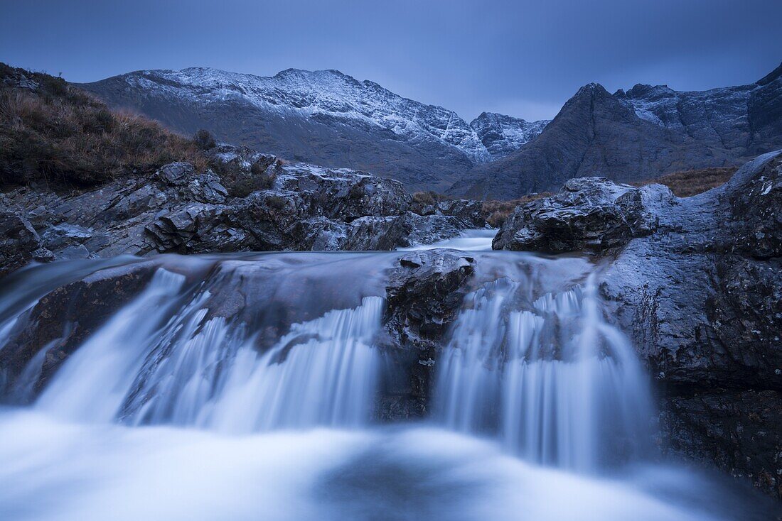 Fairy Pools waterfalls at Glen Brittle, with the snow dusted Cuillin mountains beyond, Isle of Skye, Inner Hebrides, Scotland, United Kingdom, Europe