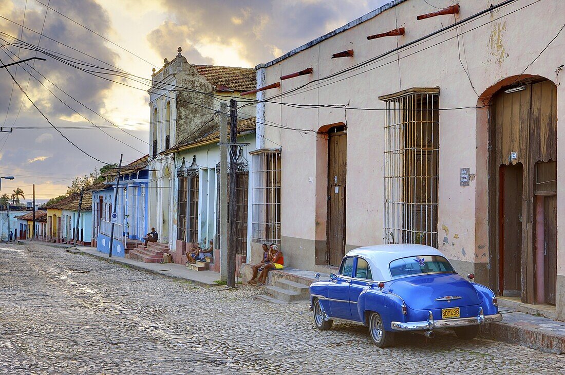 Cobbled street at sunset with classic American car, Trinidad, Cuba, West Indies, Central America
