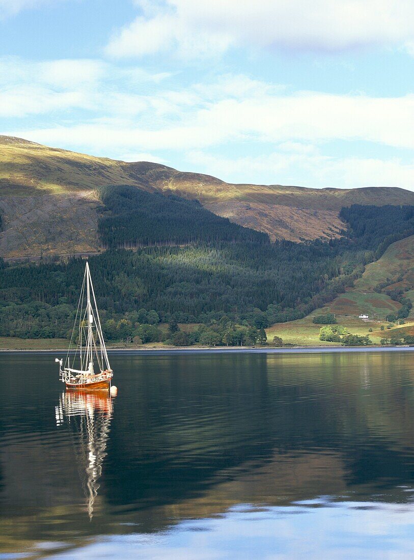 Wooden yacht on Loch Leven, in autumn, Glencoe, Highland region, Scotland, United Kingdom, Europe