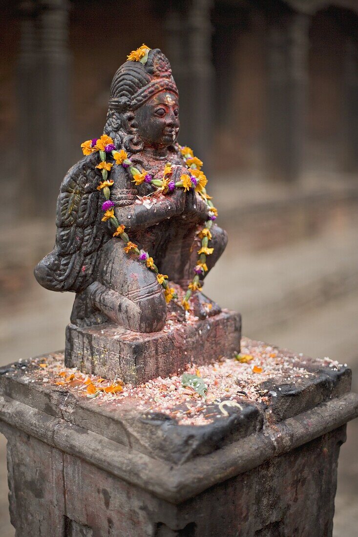 Garuda statue with pooja offerings, Bhaktapur, Kathmandu valley, Nepal, Asia