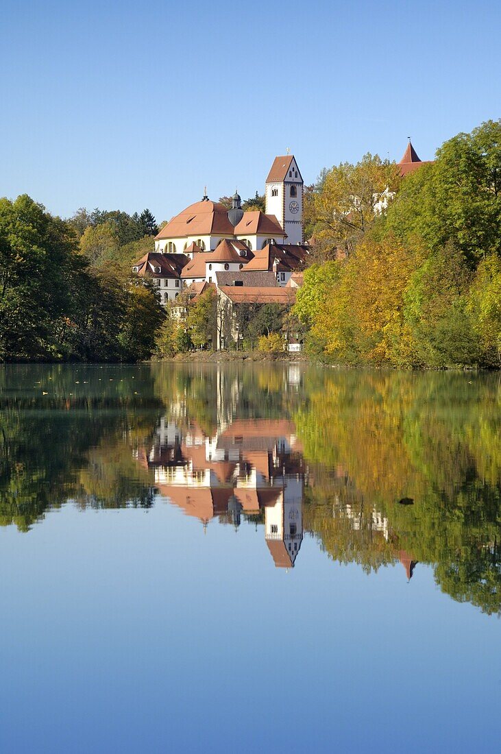 St. Mang Monastery and Basilica reflected in the river Lech, Fussen, Bavaria (Bayern), Germany, Europe