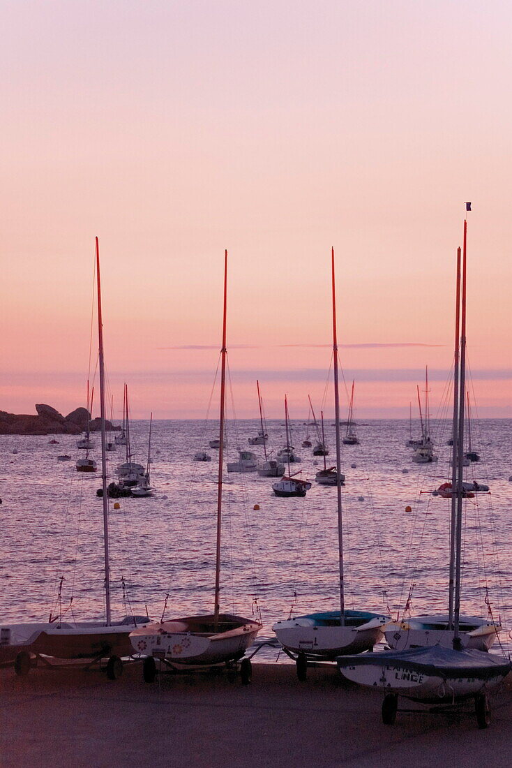 Sunset over boats, Tregastel, Cote de Granit Rose, Cotes d'Armor, Brittany, France, Europe