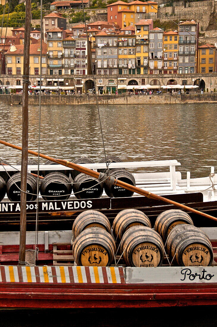 Port wine barrels on a boat on River Douro with Vila Nova de Gaia in the background, Porto, Portugal, Europe