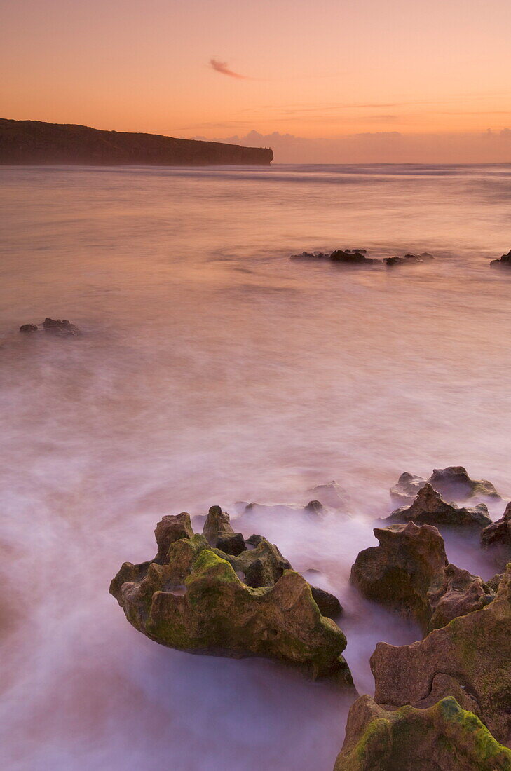 Sunset over blurred milky water, Amoreira beach near Alzejur, Algarve, Portugal, Europe