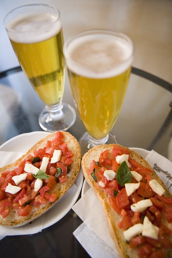 Snack of beer and bruschetta in cafe, Siena, Tuscany, Italy, Europe